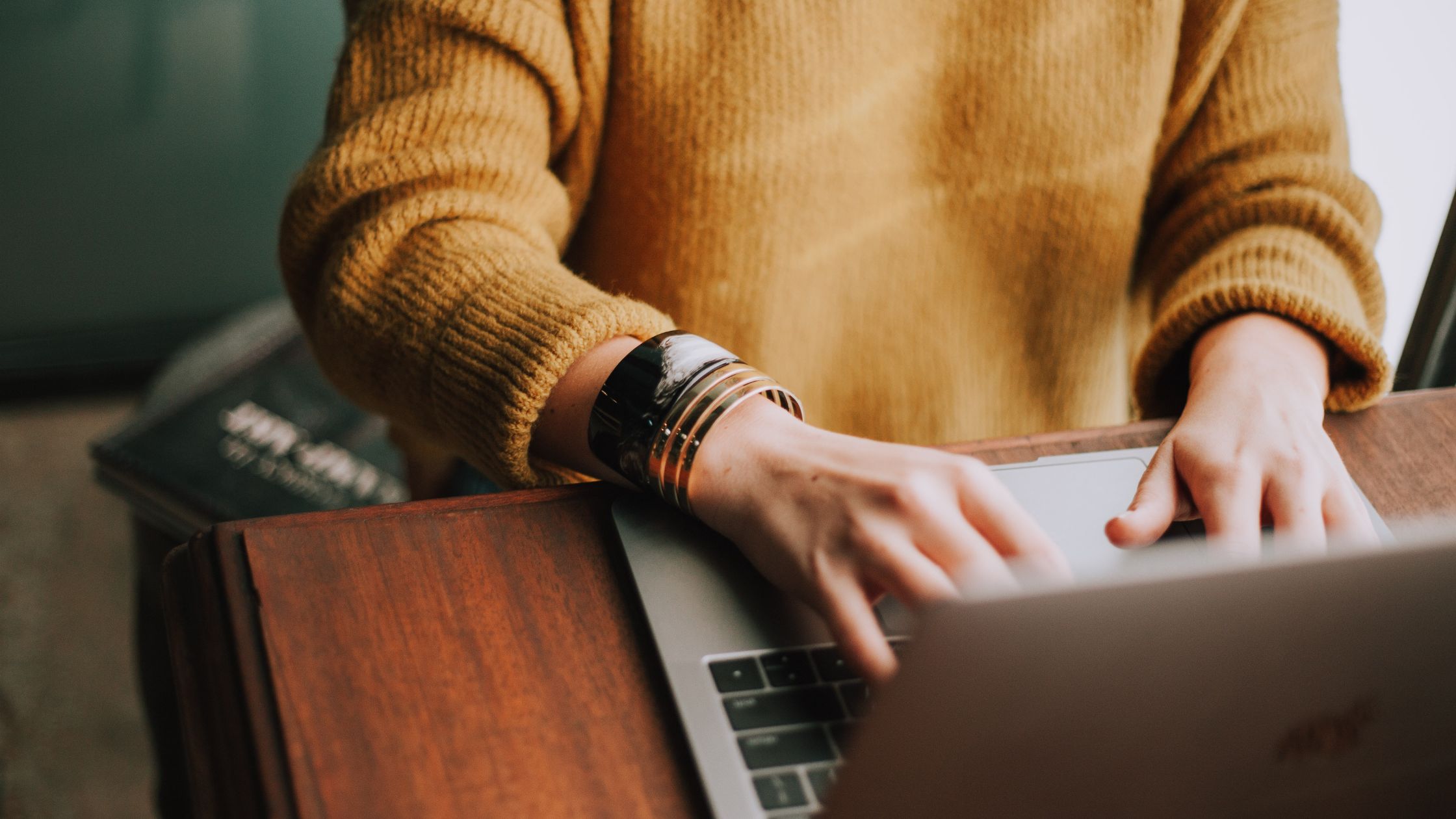 Close up photo of a female German Freelancer typing on a laptop.